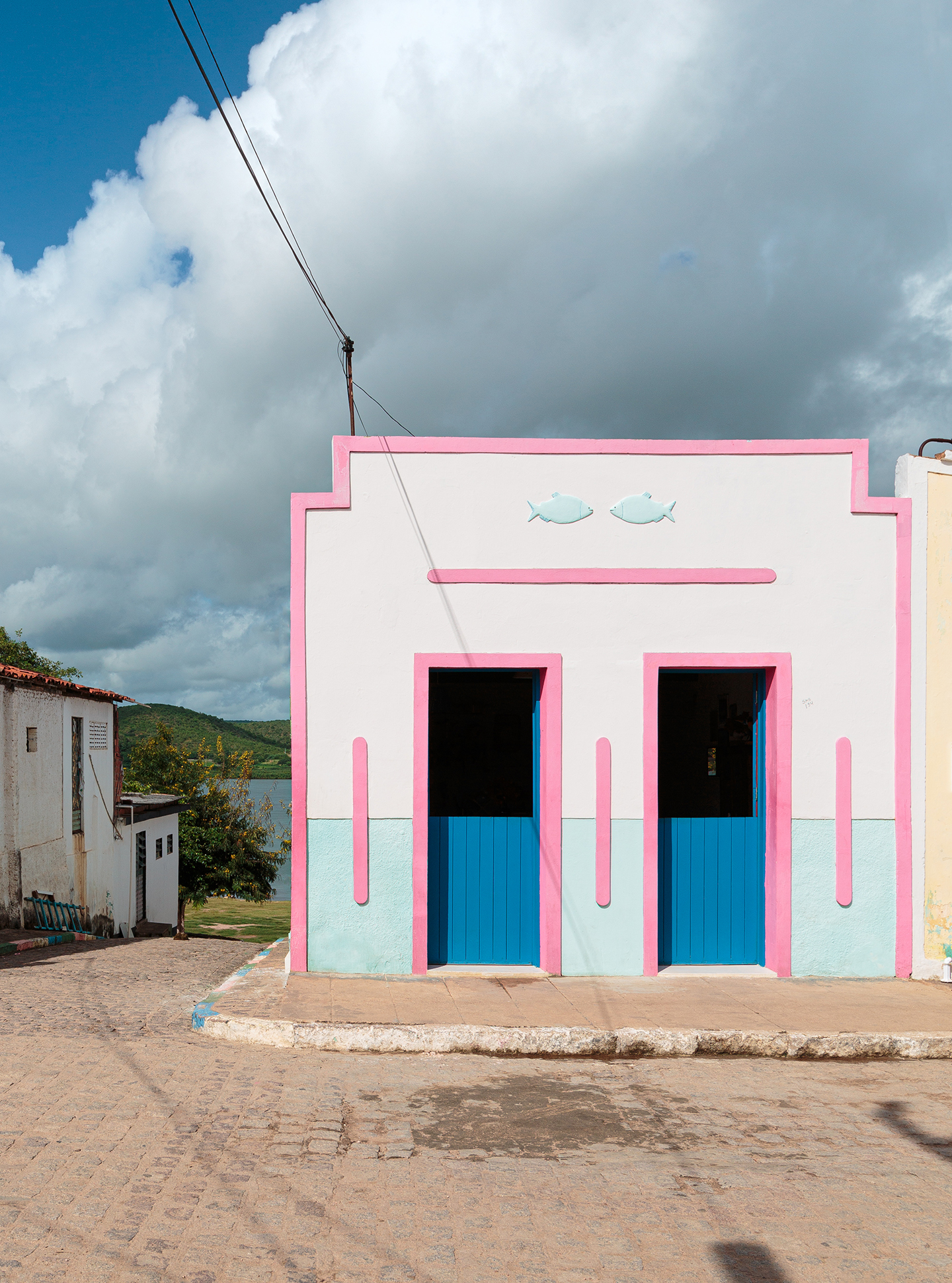 Casa Pirambeba na Ilha do Ferro com fachada colorida e decoração com peças de artesanato popular.